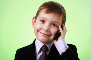 bigstock_Smiling_Little_Boy_With_Cell_P_6509497